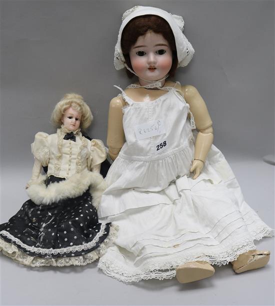 A wax headed doll and a German Bisque headed doll